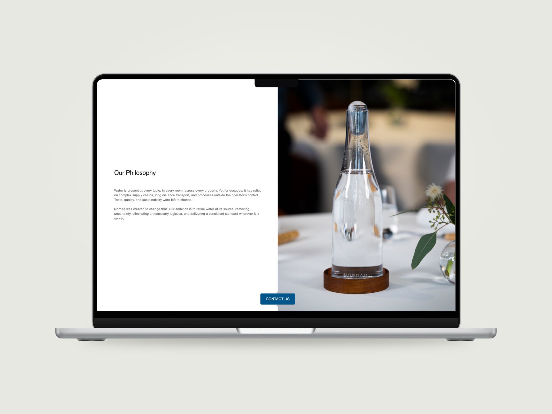 The Nordaq About page on a MacBook: Our Philosophy beside a bottle on a set table, a Contact us bar at the bottom