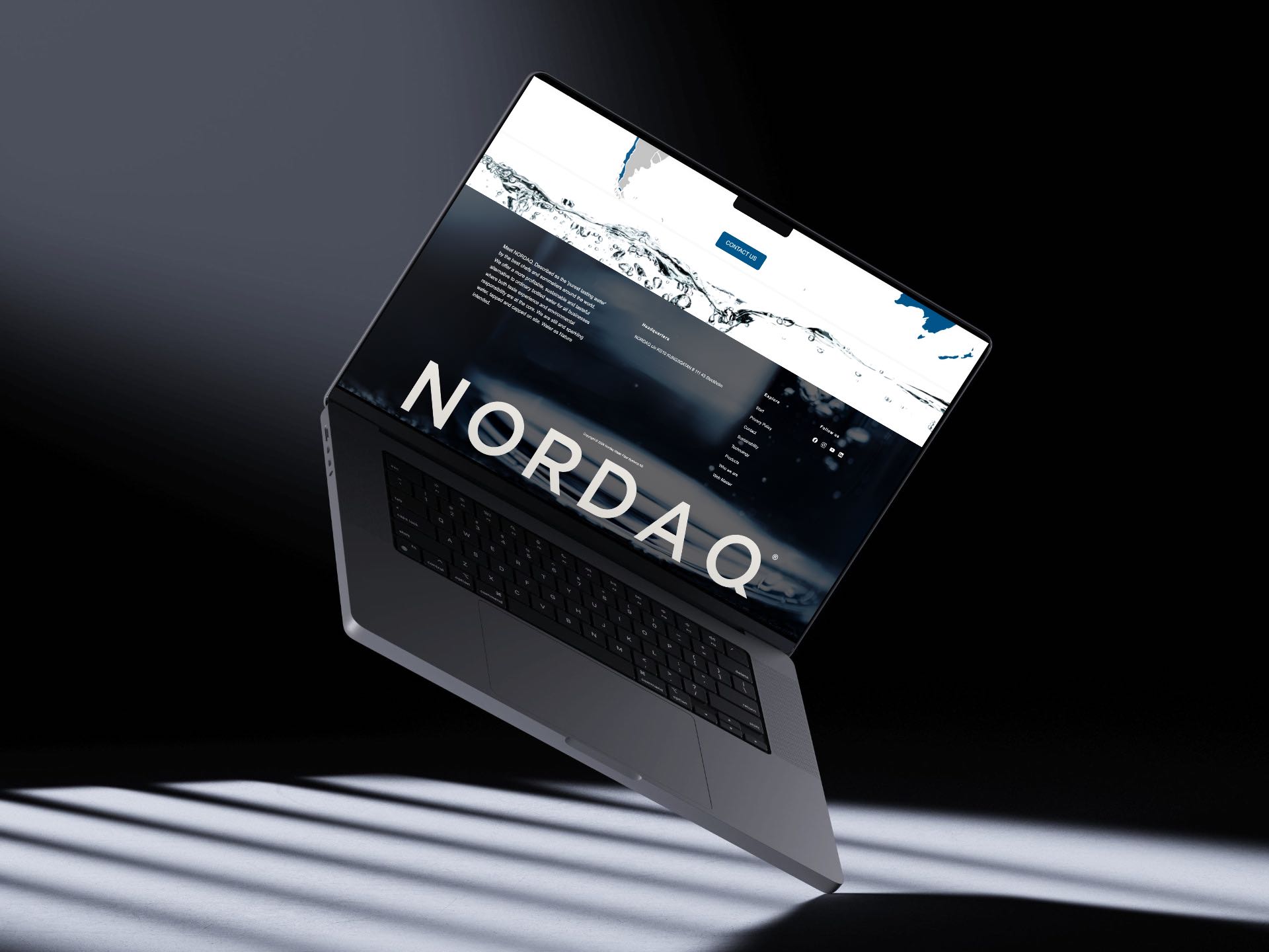 The new Nordaq footer on a floating MacBook, the NORDAQ wordmark set large over dark water
