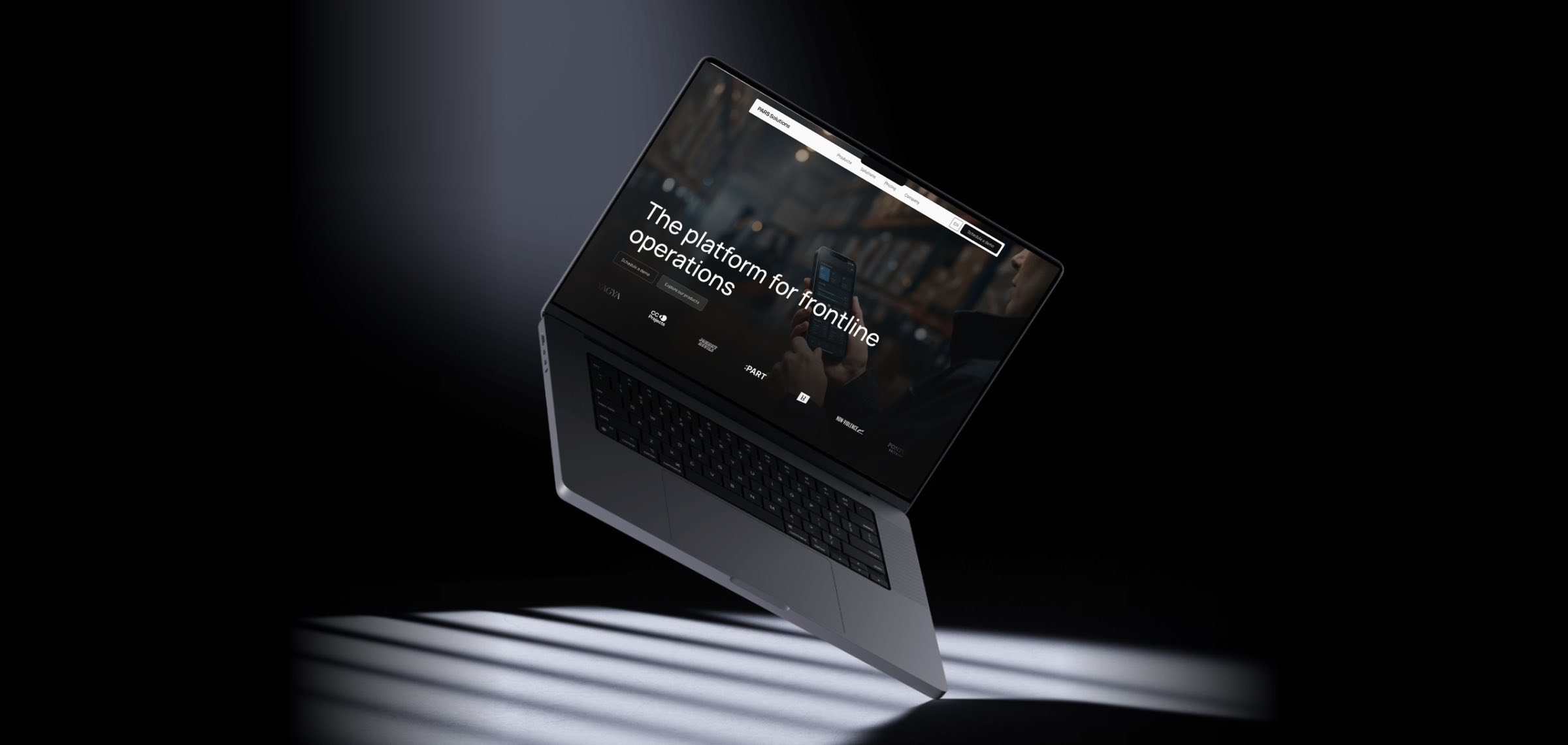 The new parssolutions.io home page on a floating MacBook: The platform for frontline operations, over a warehouse photo