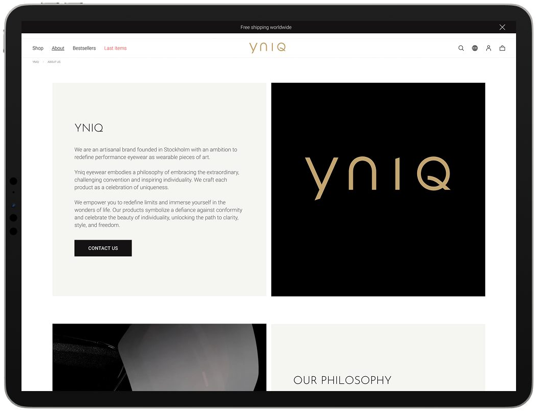 iPad showing the YNIQ about page, the yniq wordmark in gold on a black panel beside the brand text