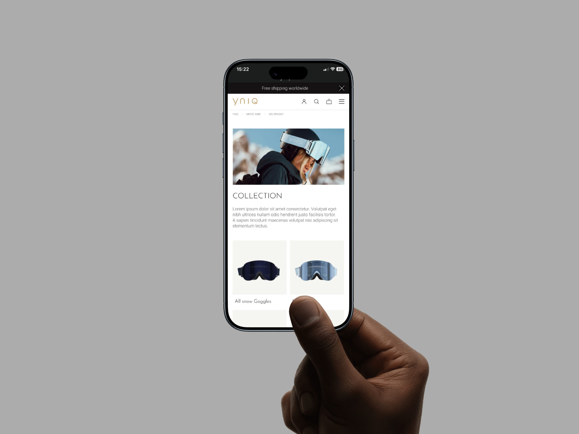 Hand holding a phone with the YNIQ collection page
